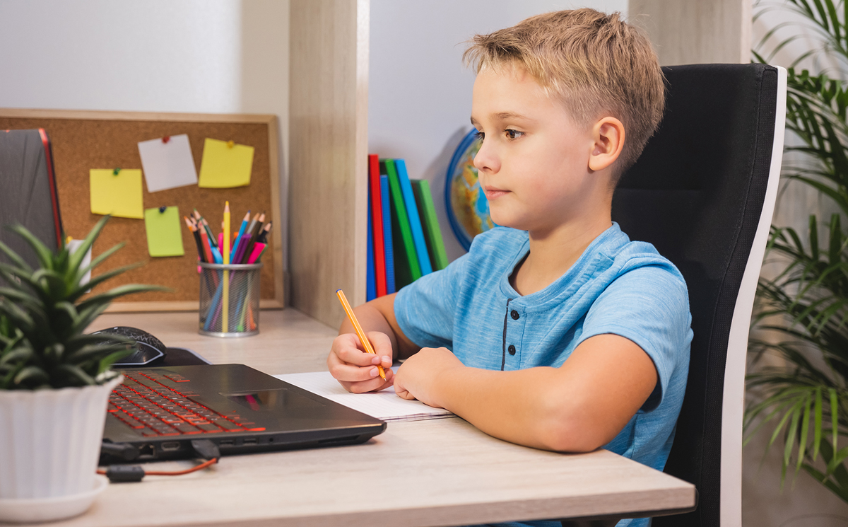 Elementary student learning at home with laptop