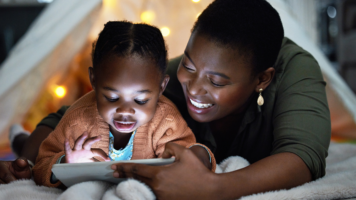 Mother and daughter on digital tablet together