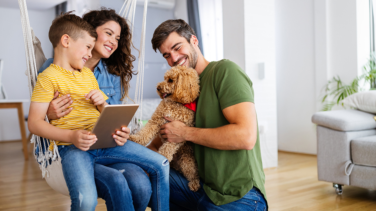 Young family and dog on digital tablet together