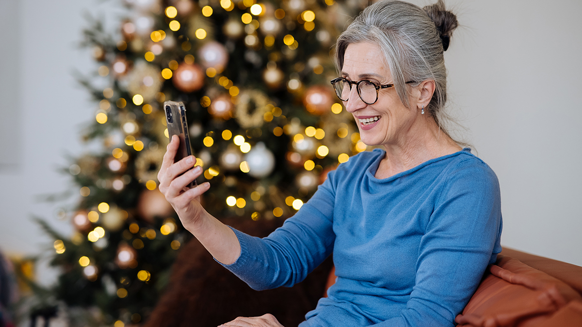Woman on video call in front of Christmas tree