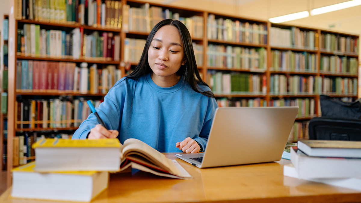 Student doing homework in school library