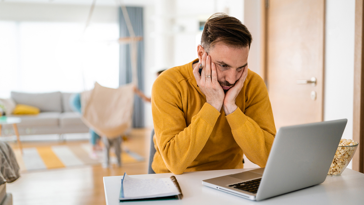 Man annoyed while waiting for slow computer