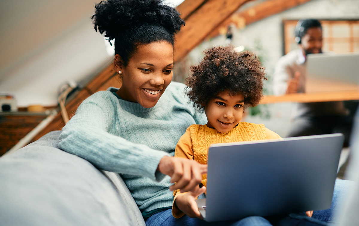 Mom and child looking at laptop together