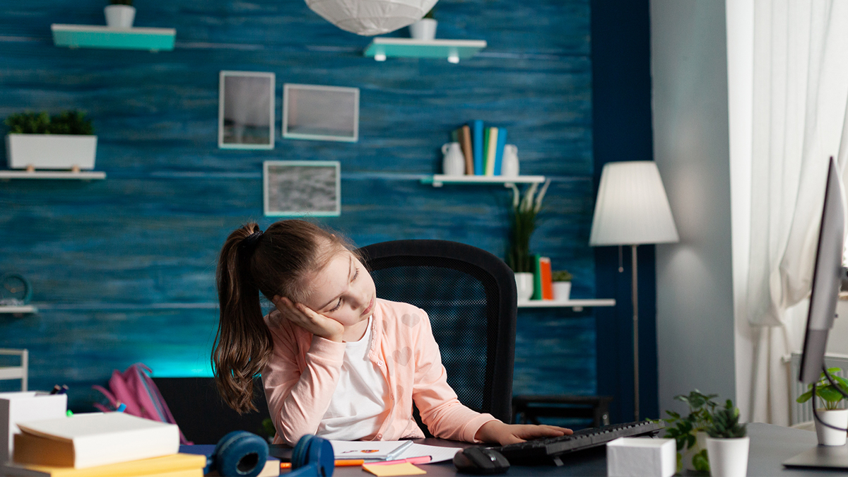 Young girl bored on computer