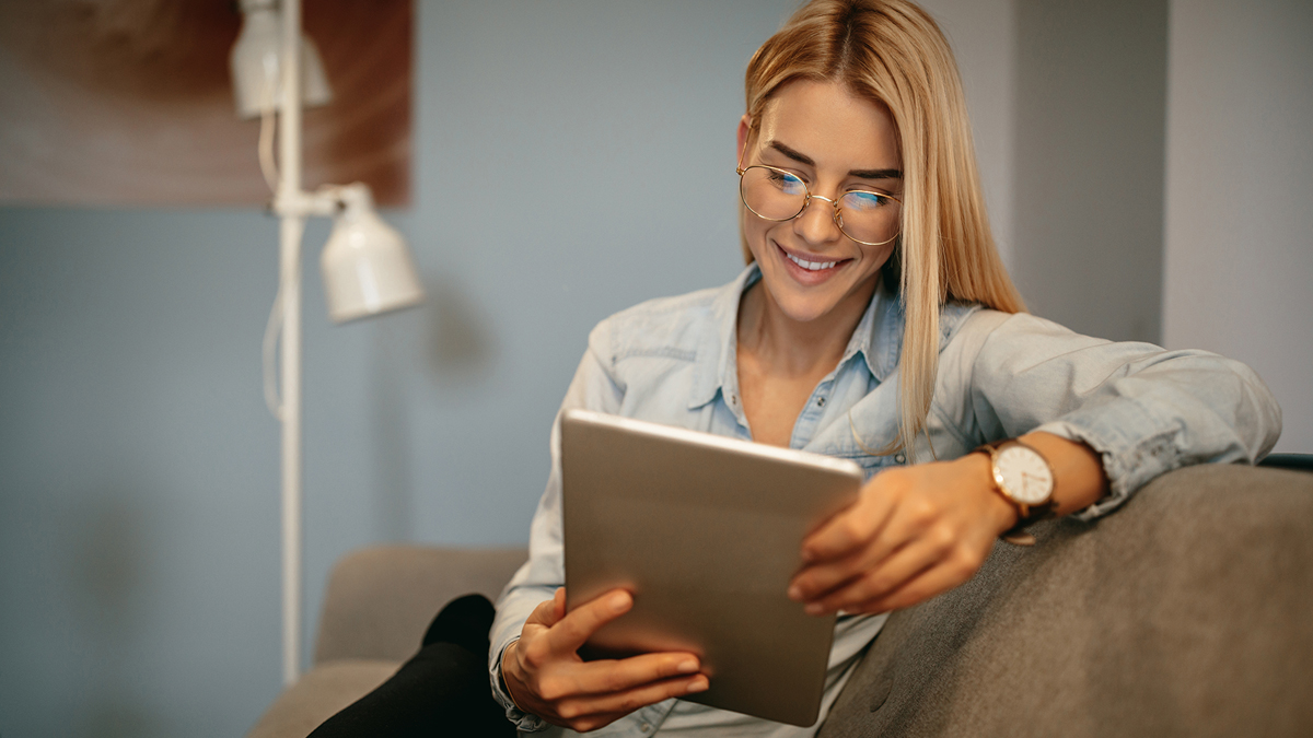 Woman reading on digital tablet