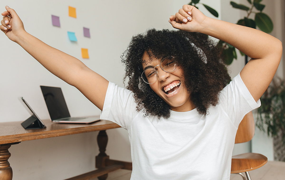 Woman dancing to music with headphones on