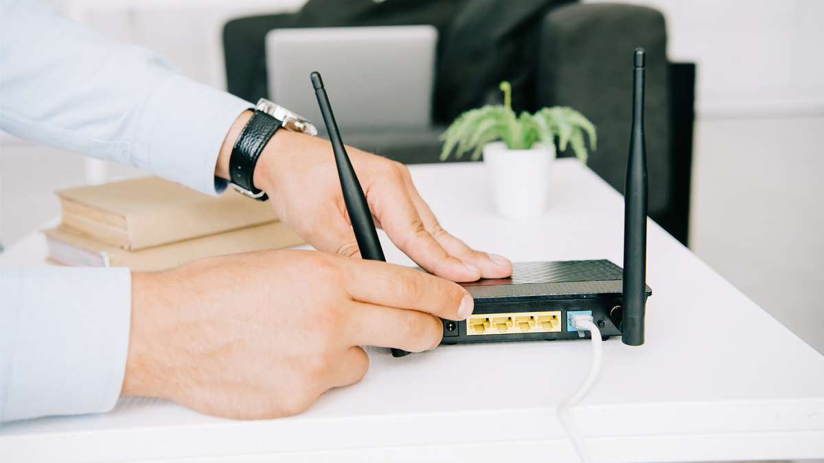 Hands turning on router