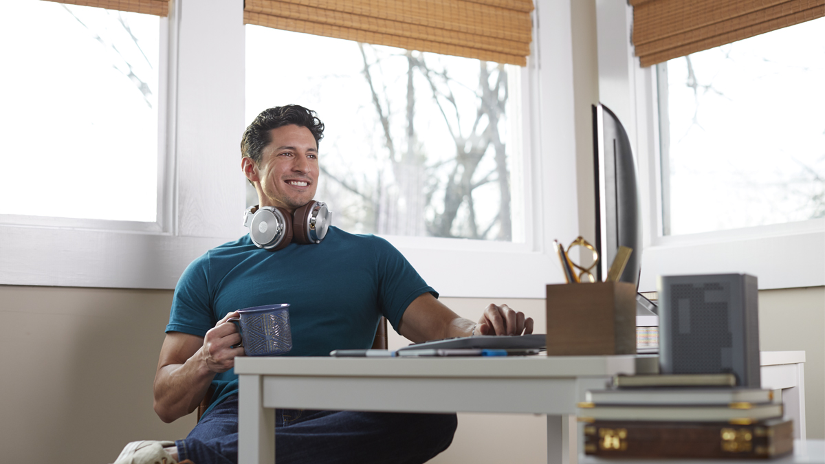 Man working from home with Kosciusko Connect router beside desk