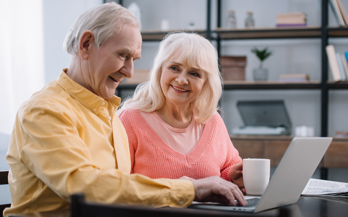 Senior couple looking at laptop together