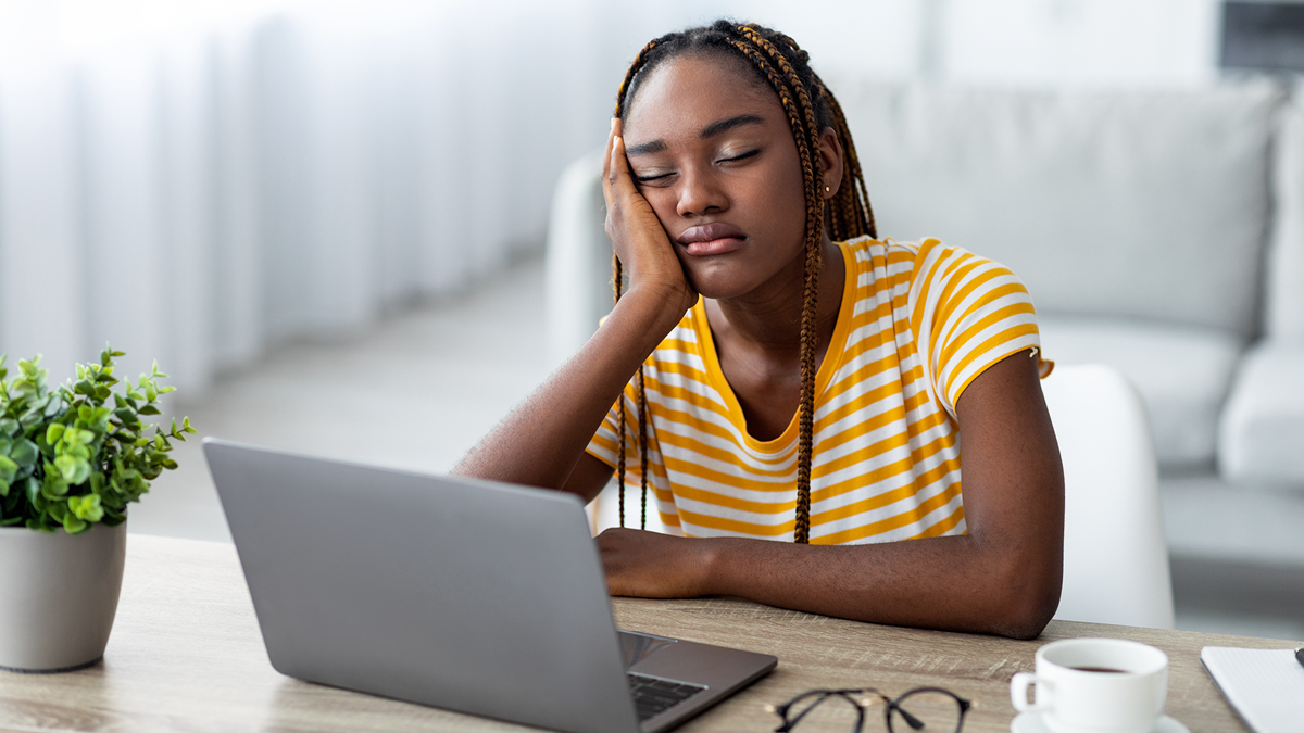 Young woman bored while waiting for slow computer