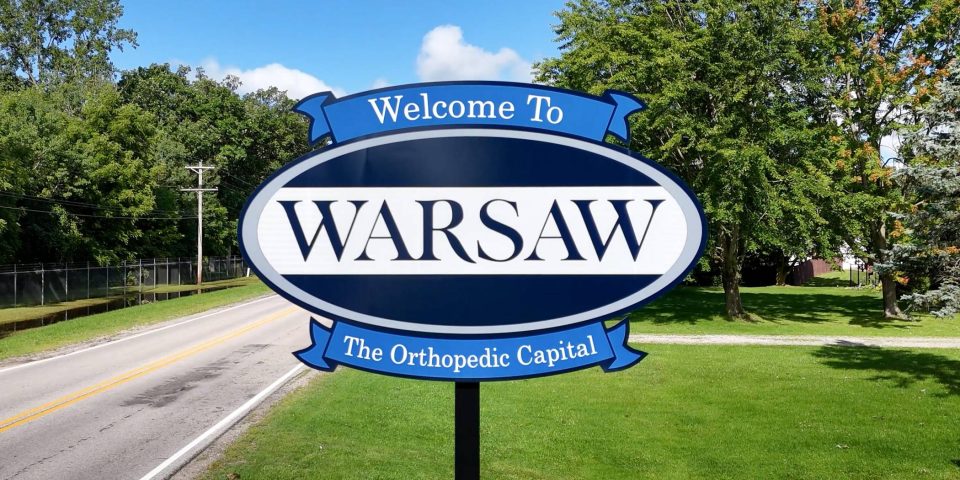 A sign reads Welcome to Warsaw - The Orthopedic Capital